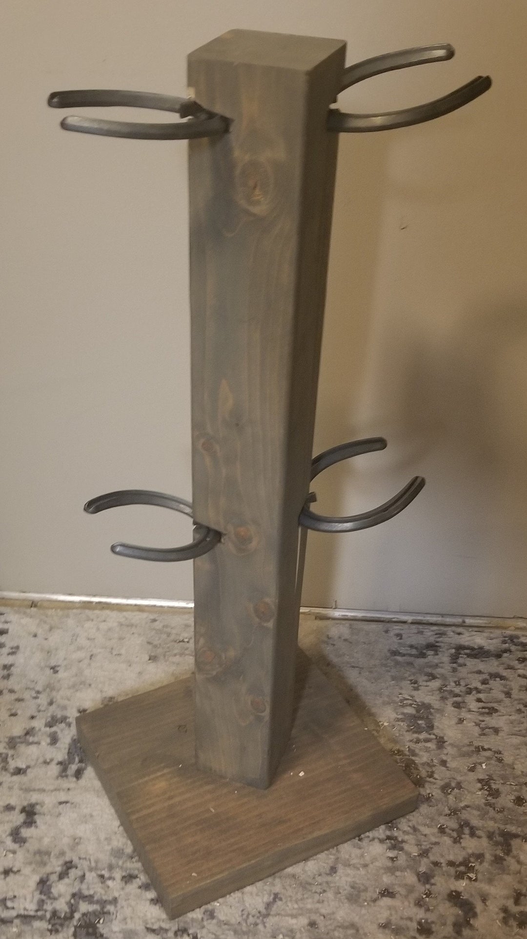 4-pair cowboy boot floor stand with multiple curved metal holders and wooden base