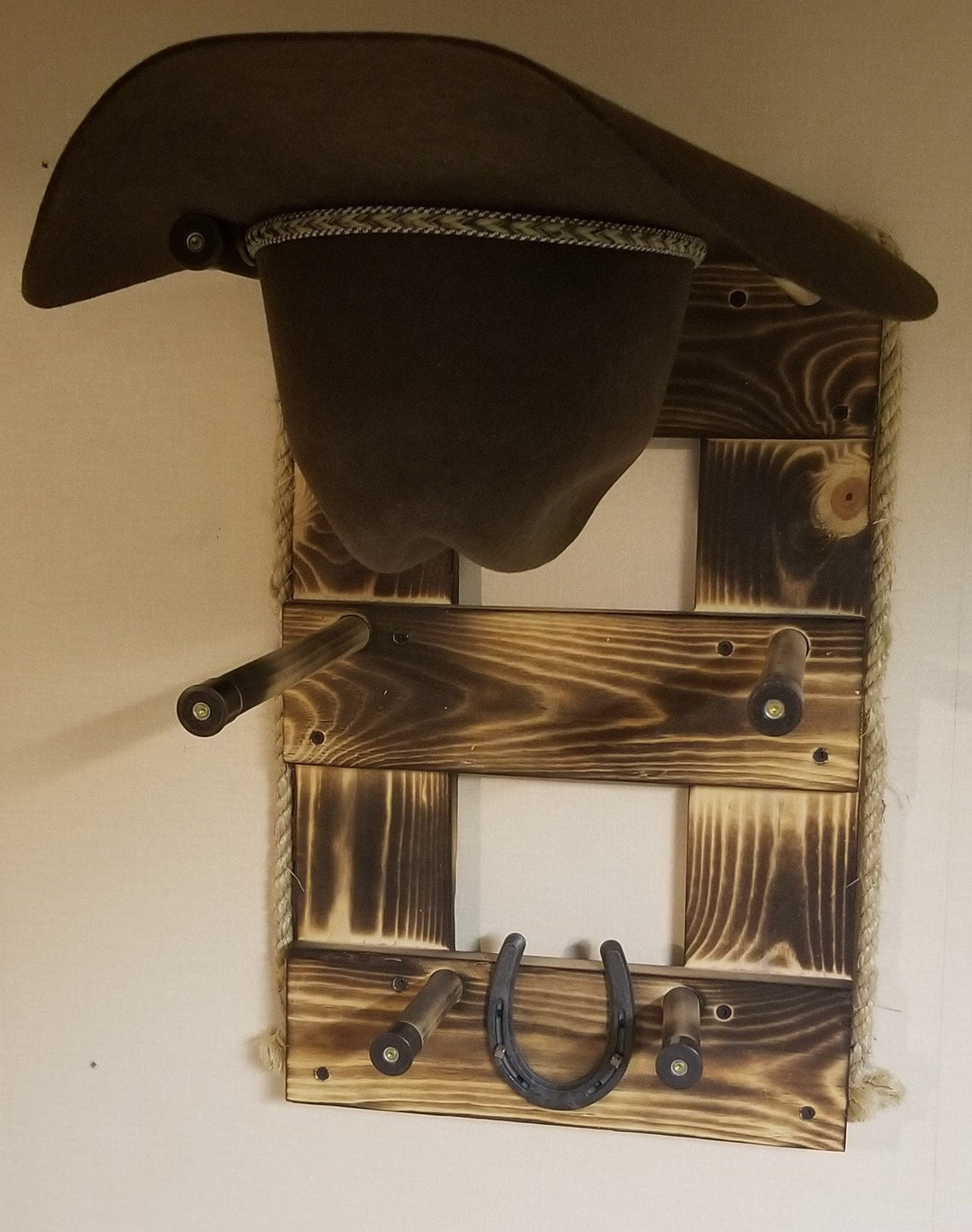 Brown wood vertical wall organizer with two hat compartments and three hanging hooks