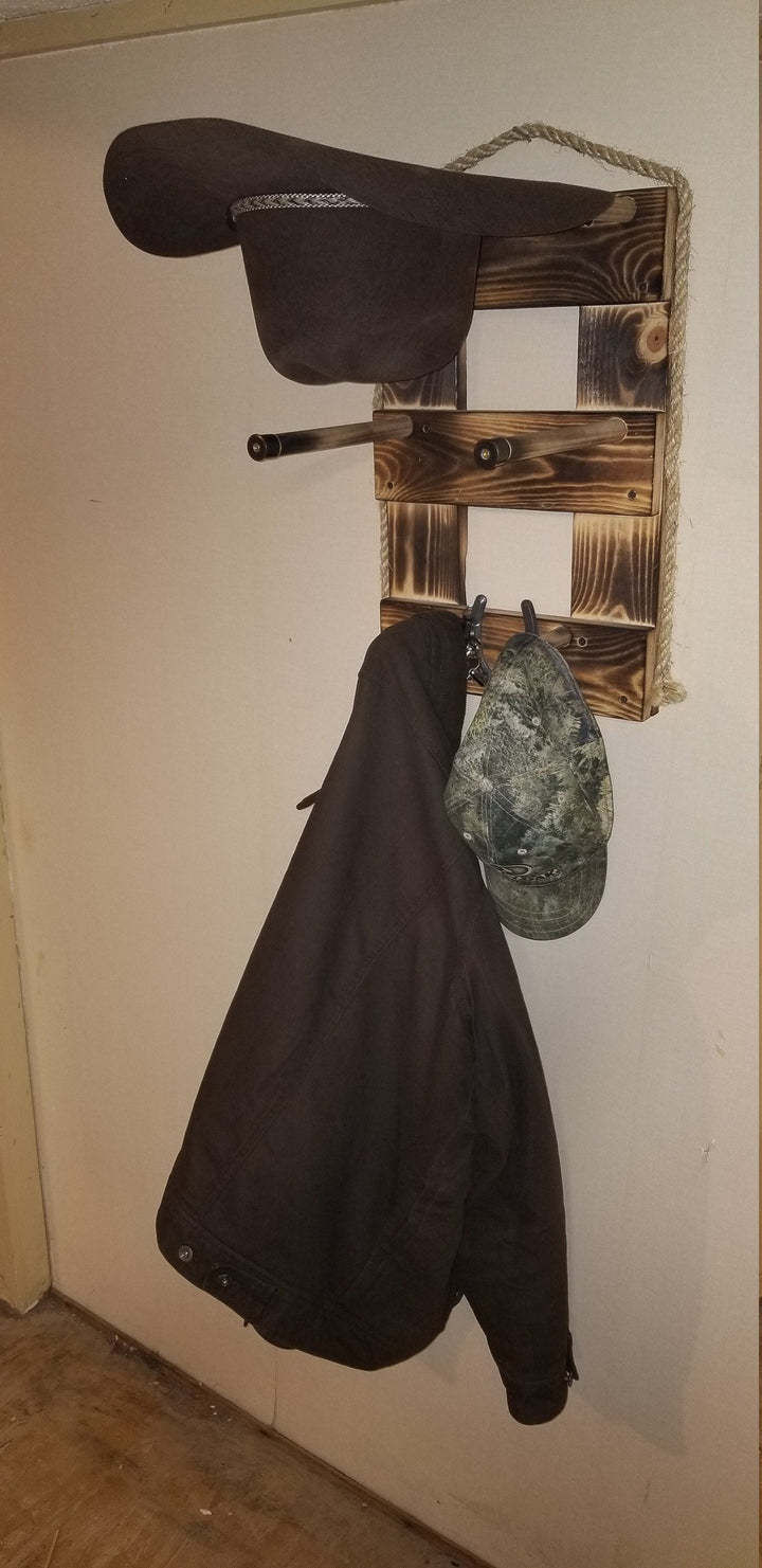 Brown vertical wall organizer with hat slots and hooks holding hanging hats