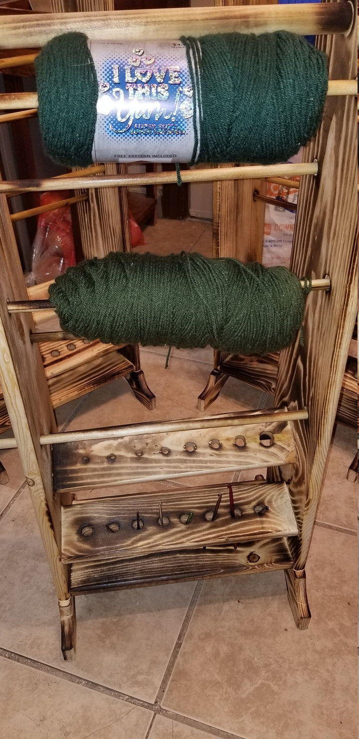 Wooden yarn holder with stacked green yarn skeins on peg shelves