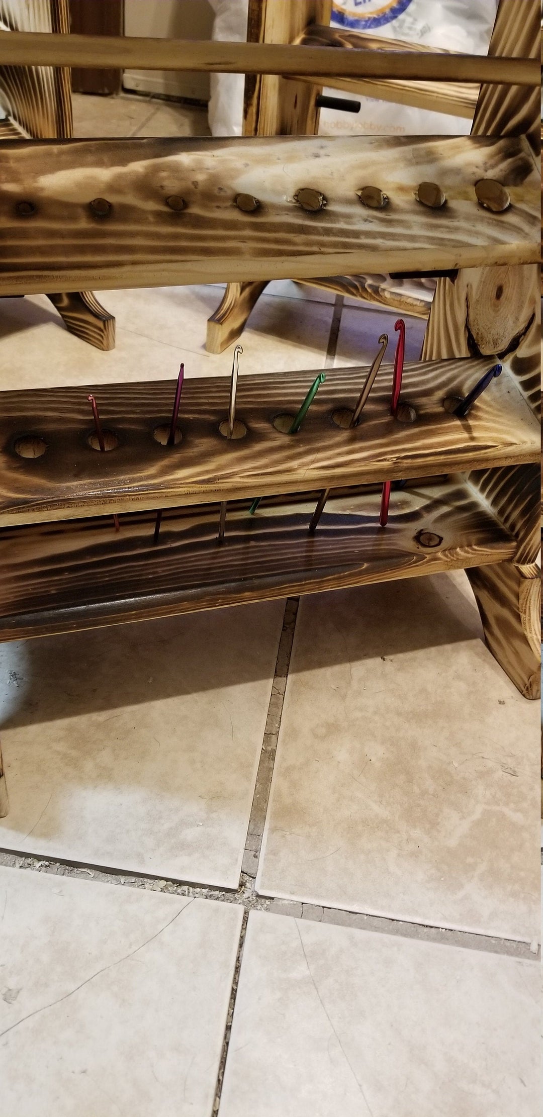 Wooden yarn holder with lower peg bar and colorful yarn pins