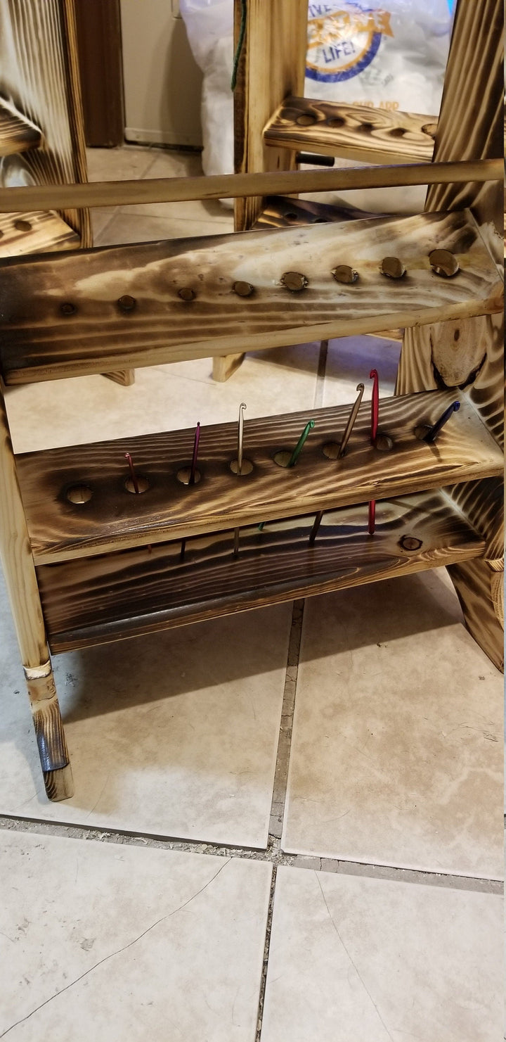 Wooden yarn holder with two horizontal peg bars and hanging yarn pins