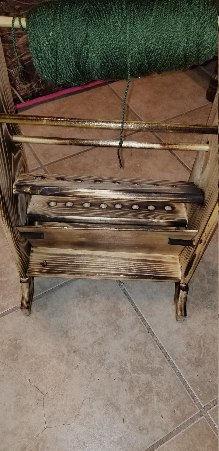 Wooden yarn holder with top green yarn skein and peg bars