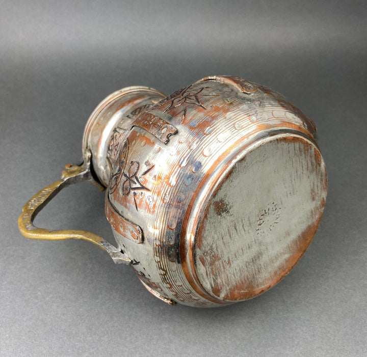 Copper coffee pot exterior with engraved bands, curved handle and matching domed lid