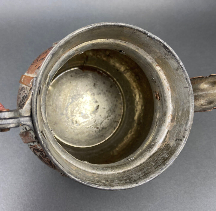 Vintage copper coffee pot lid with circular silvered base opening, ornate rim engravings