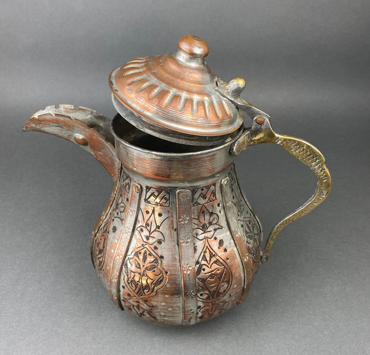 Copper coffee pot with domed lid and engraved panels, curved handle and spout