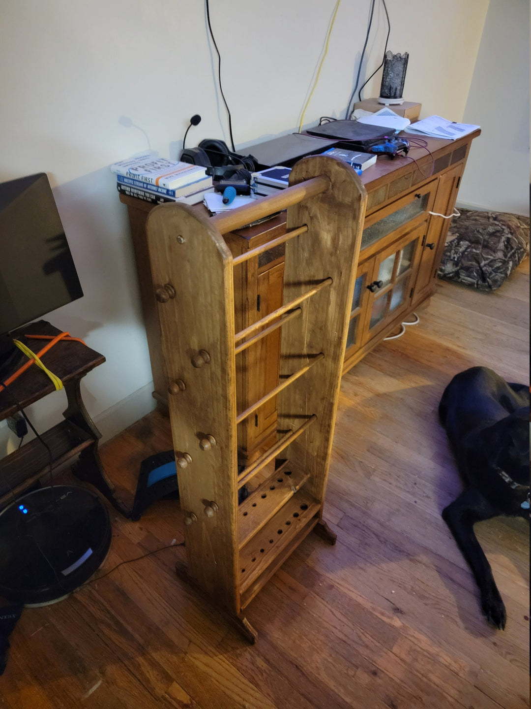 Wooden yarn holder organizer with pegs and tiered shelves on a standing rack