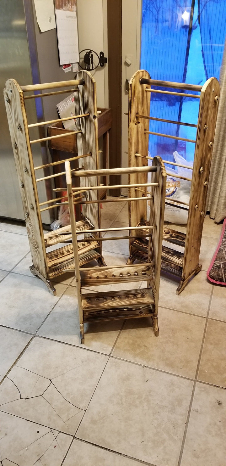 Set of wooden yarn holder racks with horizontal bars, shelves, and peg holes