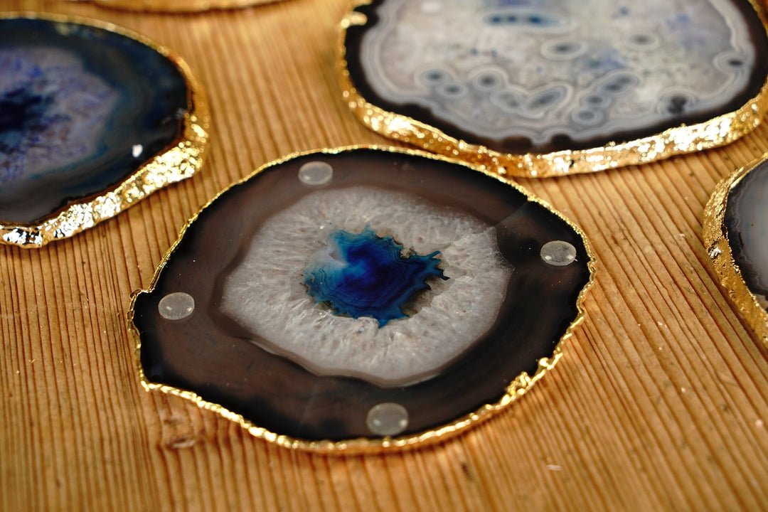 Round blue agate coaster close-up with gold rim and small clear rubber feet on top