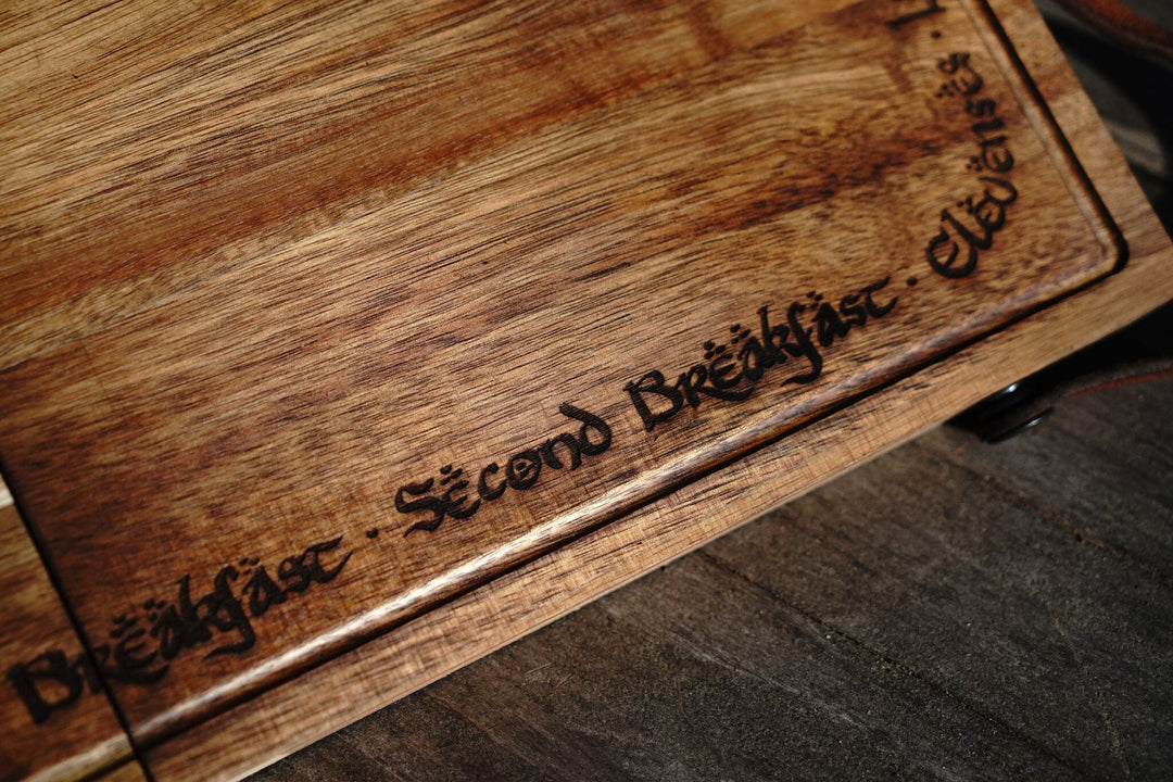 Close-up of engraved text on acacia folding cutting board edge and surface grain