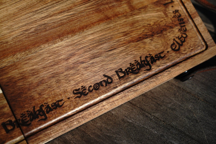 Close-up of engraved text on acacia folding cutting board edge and surface grain