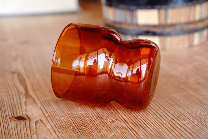 Amber orange glass with heart-shaped handle-like detail
