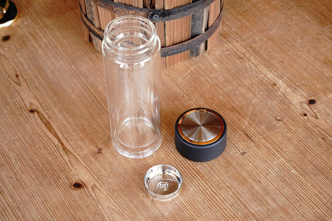 Double-walled tea infuser tumbler with separate infuser basket and black lid