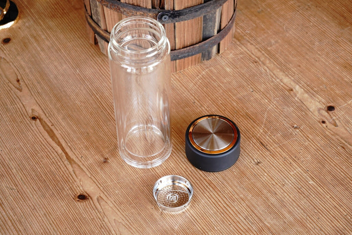 Double-walled tea infuser tumbler with separate infuser basket and black lid