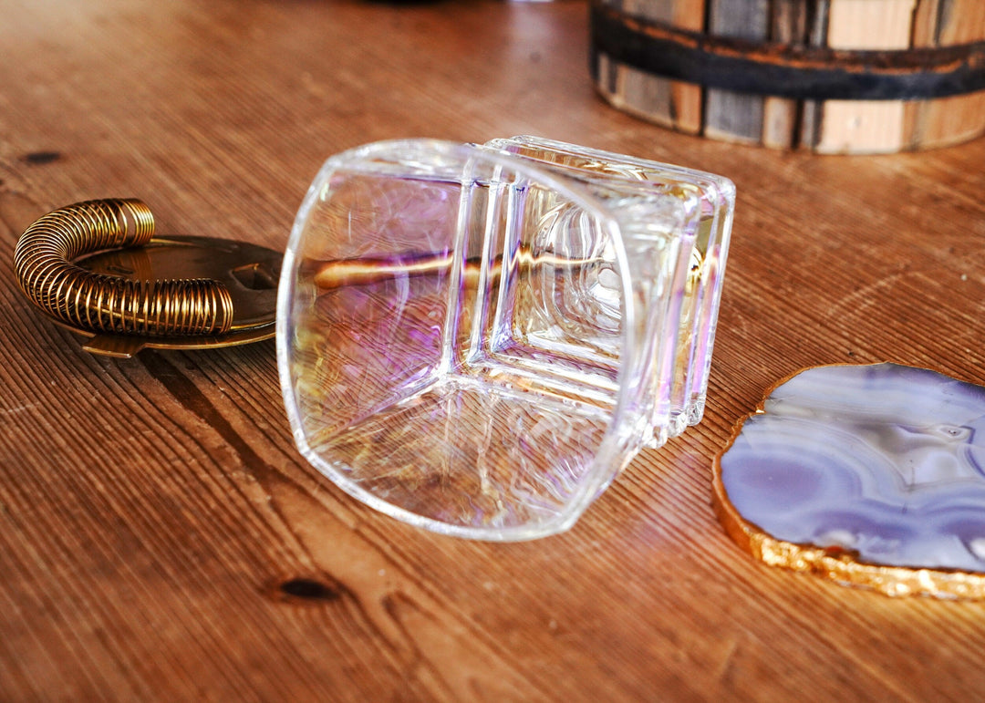 Iridescent whiskey glass with square-cut corners, shown from three-quarter angle