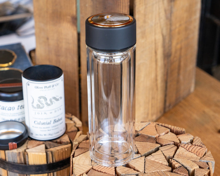 Tea infuser glass tumbler with black lid and gold center accents