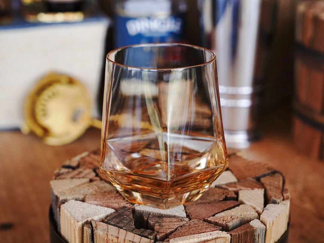 Amber diamond-style bourbon tumbler with clear facets and flared rim