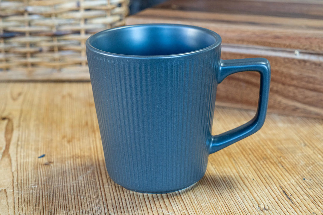 Blue ribbed ceramic mug with handle, front view