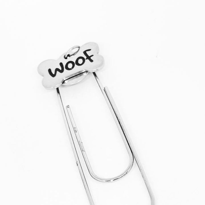 Stainless steel Woof bone paperclip bookmark charm with loop-style clip.