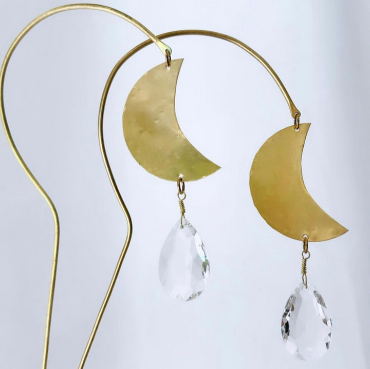 Gold metal crescent moons with clear crystal teardrop drops on a suncatcher