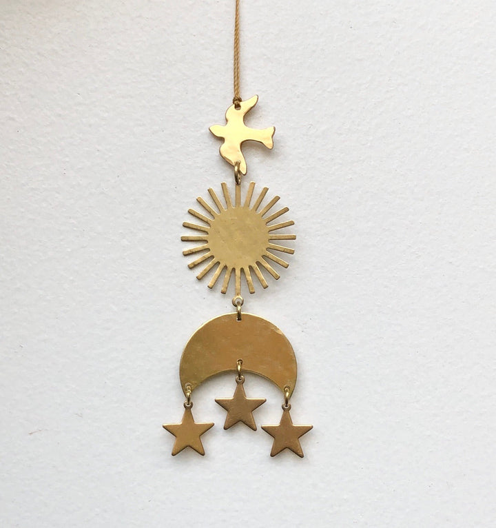 Gold hanging ornament on twine with star topper, sunburst, crescent, and three stars