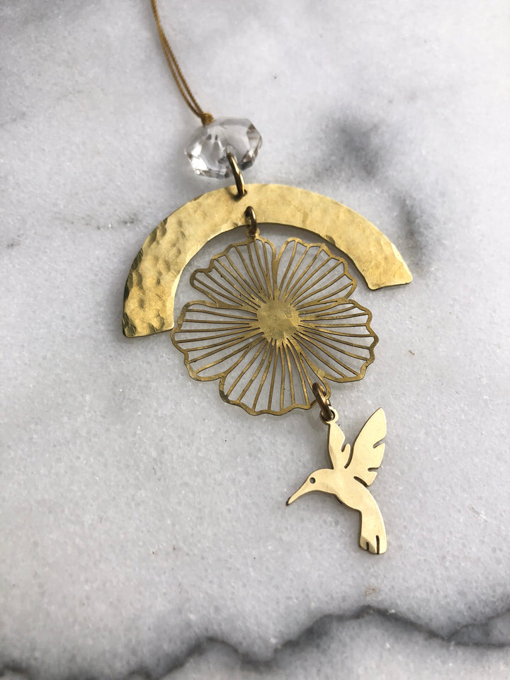 Gold hummingbird prayer ornament with filigree flower design, clear faceted glass crystal, cord loop