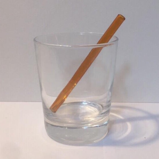 5-inch petite straw, amber orange glass-style finish, angled in clear cup
