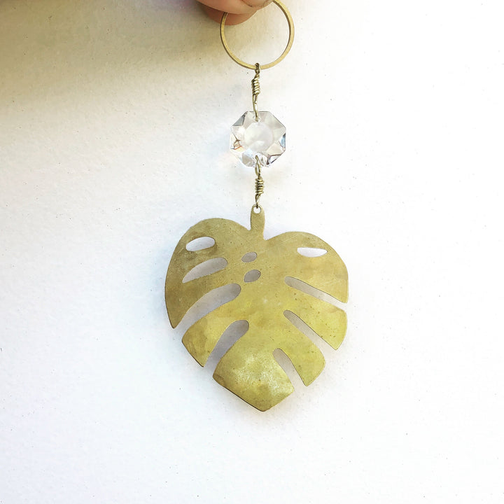 Single gold monstera leaf suncatcher with clear faceted glass crystal and top loop