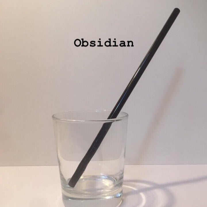 10-inch reusable straw in Obsidian black, shown diagonally in a clear drinking glass.