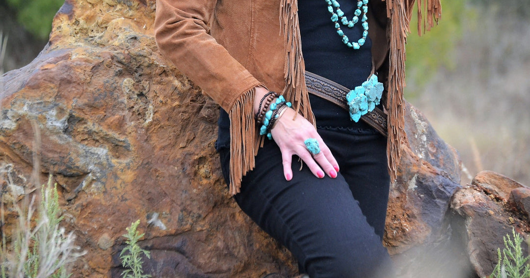 Turquoise cuff ring on hand with beaded bracelet and fringe detail