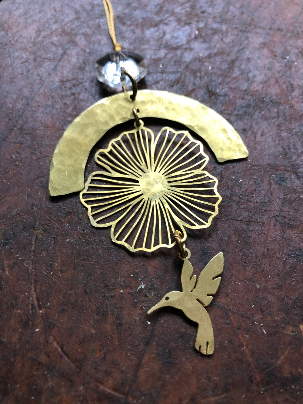 Gold prayer ornament with filigree flower and hummingbird, clear faceted glass crystal, cord