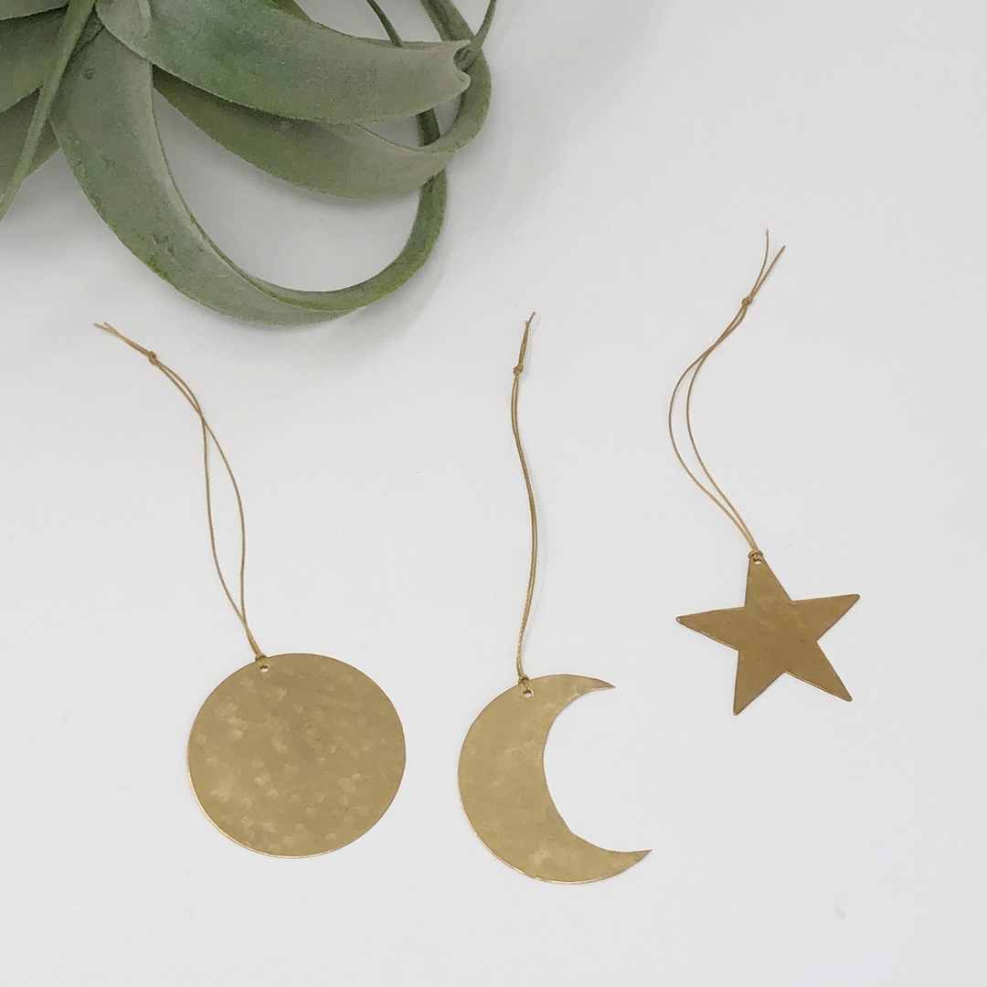 Gold celestial ornament set: round disk, crescent moon, and star with hanging cords
