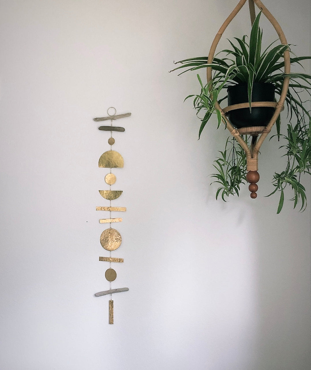 Hanging wooden ornament mobile with circular and crescent shapes
