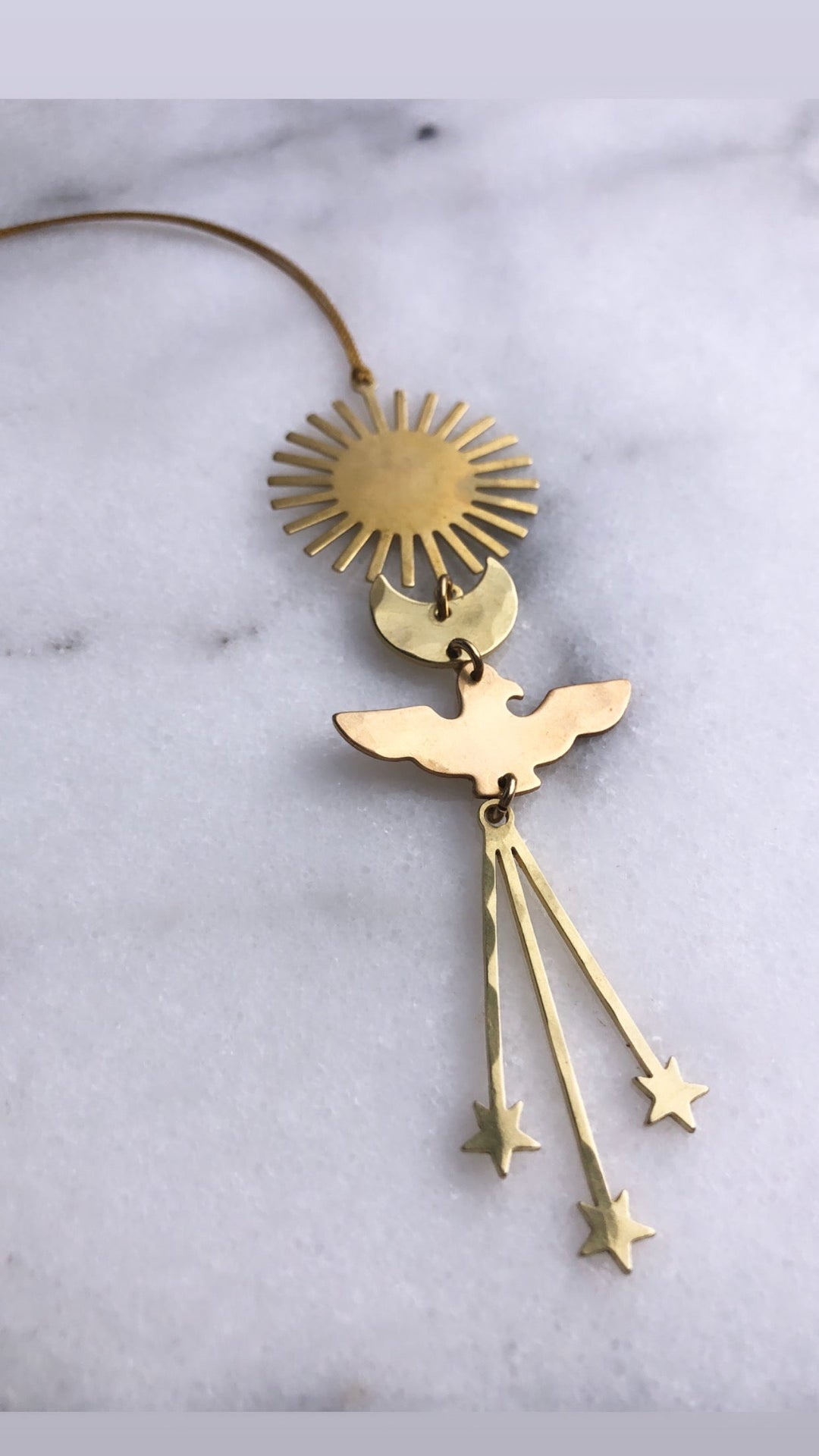 Gold angel ornament with sunburst halo, wings, and three dangling star charms