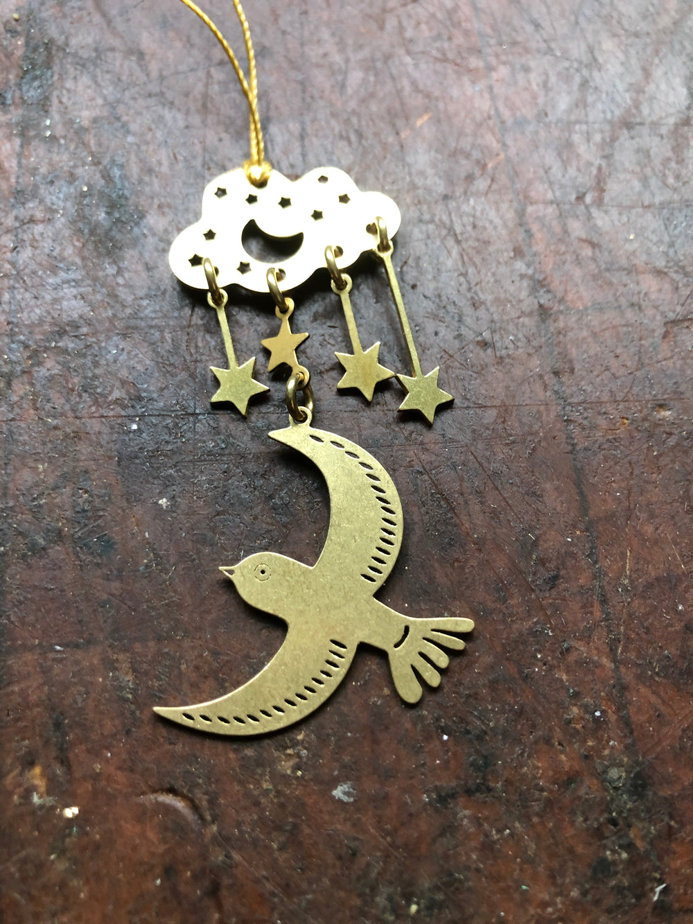 Hanging moon ornament with gold crescent bird and star charms on white round top