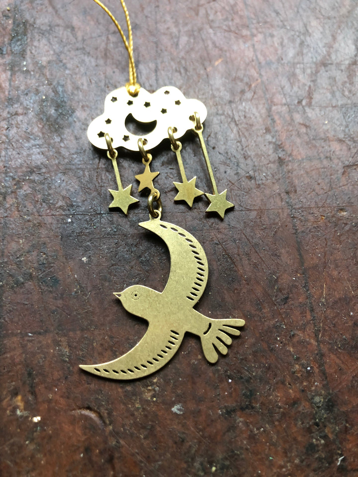 Hanging moon ornament with gold crescent bird and star charms on white round top