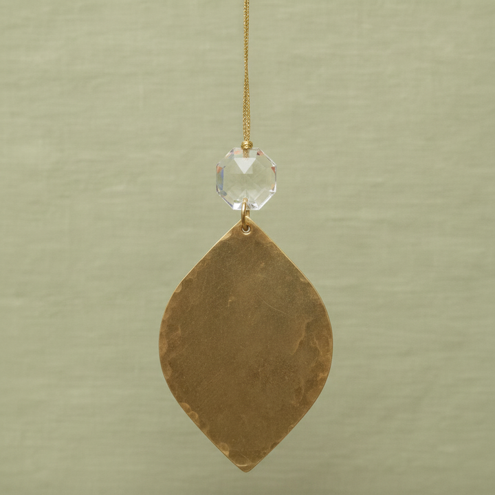 Gold teardrop ornament with clear faceted crystal cap and hanging gold cord