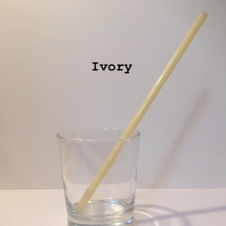 10-inch reusable straw in Ivory, shown diagonally in a clear drinking glass.