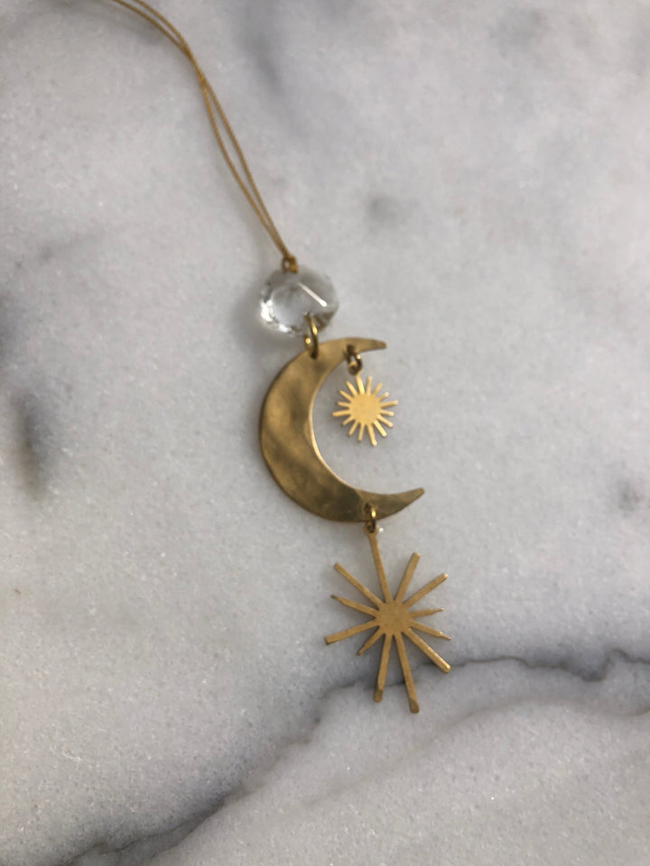 Gold crescent moon ornament with sunburst charms and clear crystal hanger
