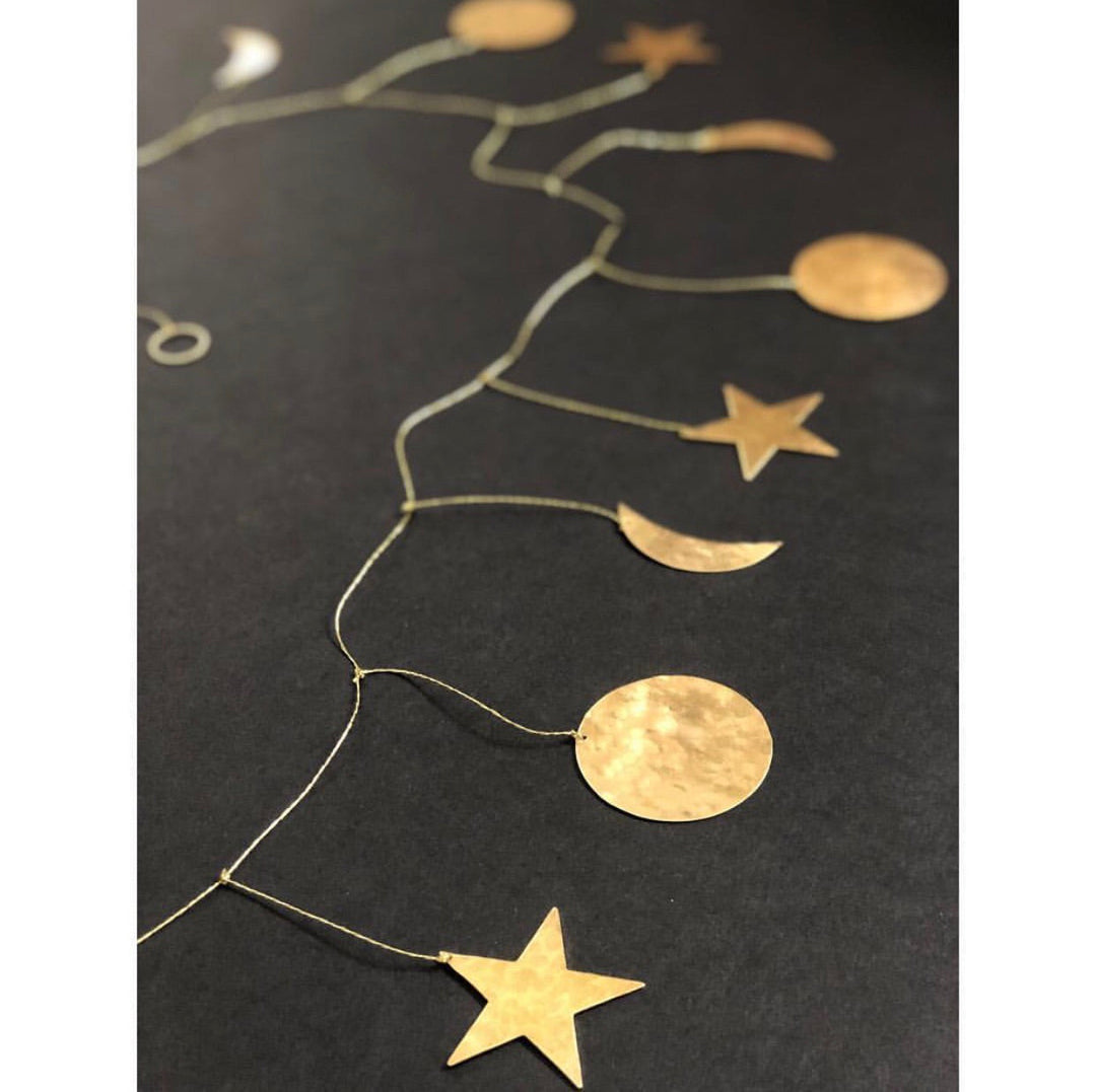 Brass star and crescent moon garland on a thin linked wire chain with hammered discs