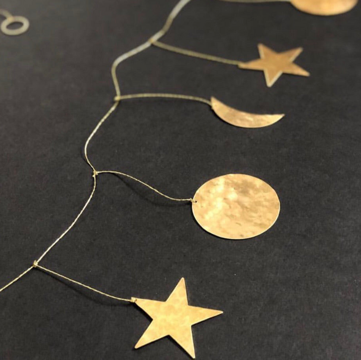 Hammered brass garland with linked chain, featuring star, crescent moon, and round discs
