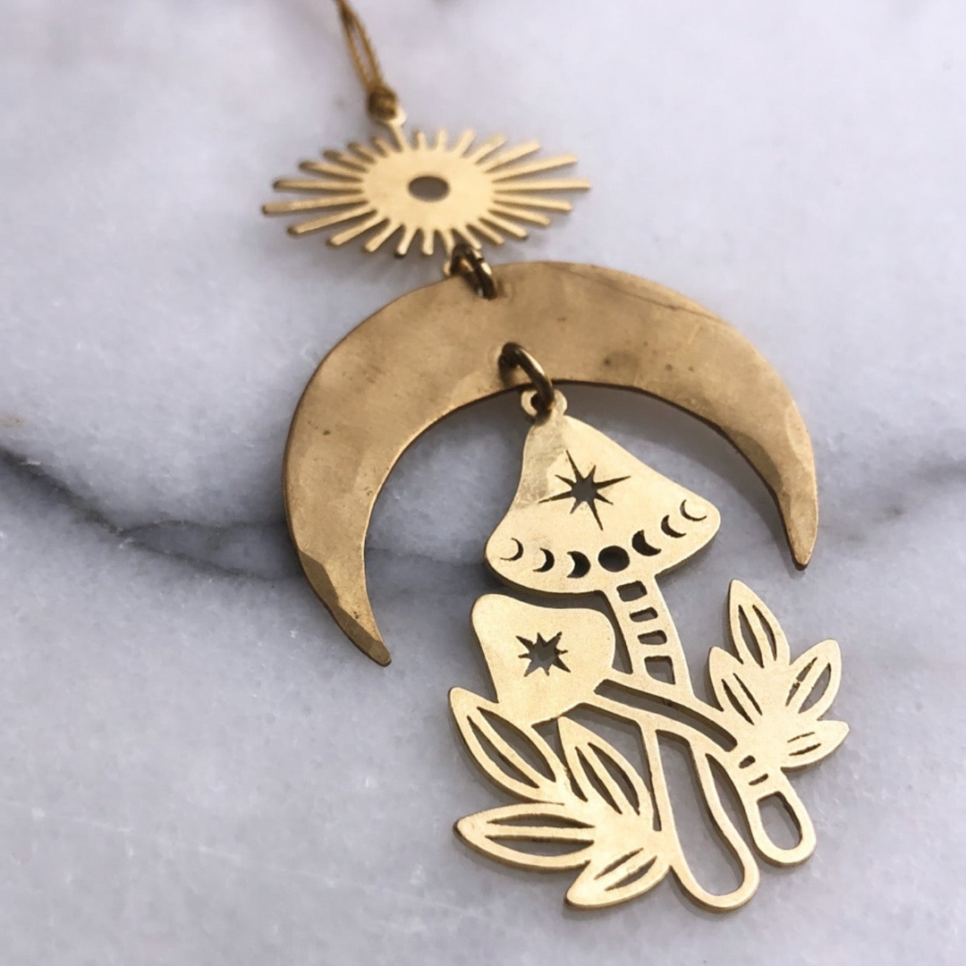 Gold mushroom ornament with crescent moon and hanging sun charm, brass-tone loop