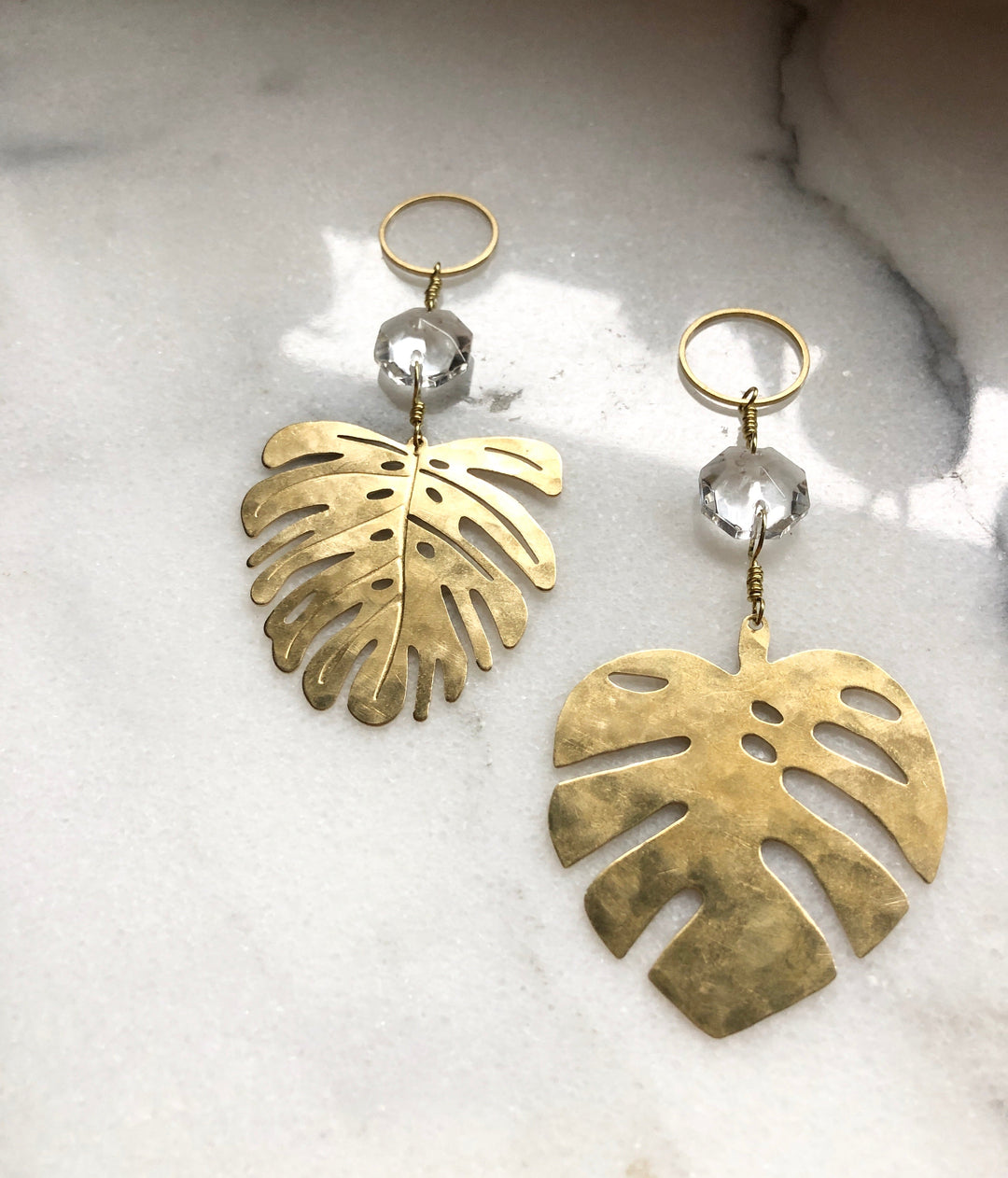 Pair of gold monstera leaf suncatchers with clear faceted glass crystals and loops
