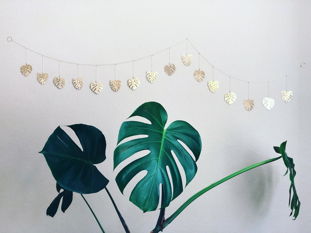 Brass leaf charm garland on thin cord, multiple hammered leaf shapes