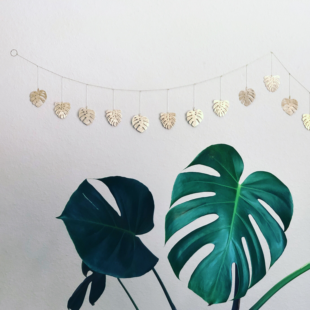 Hammered brass leaf garland with hanging leaf charms on thin cord