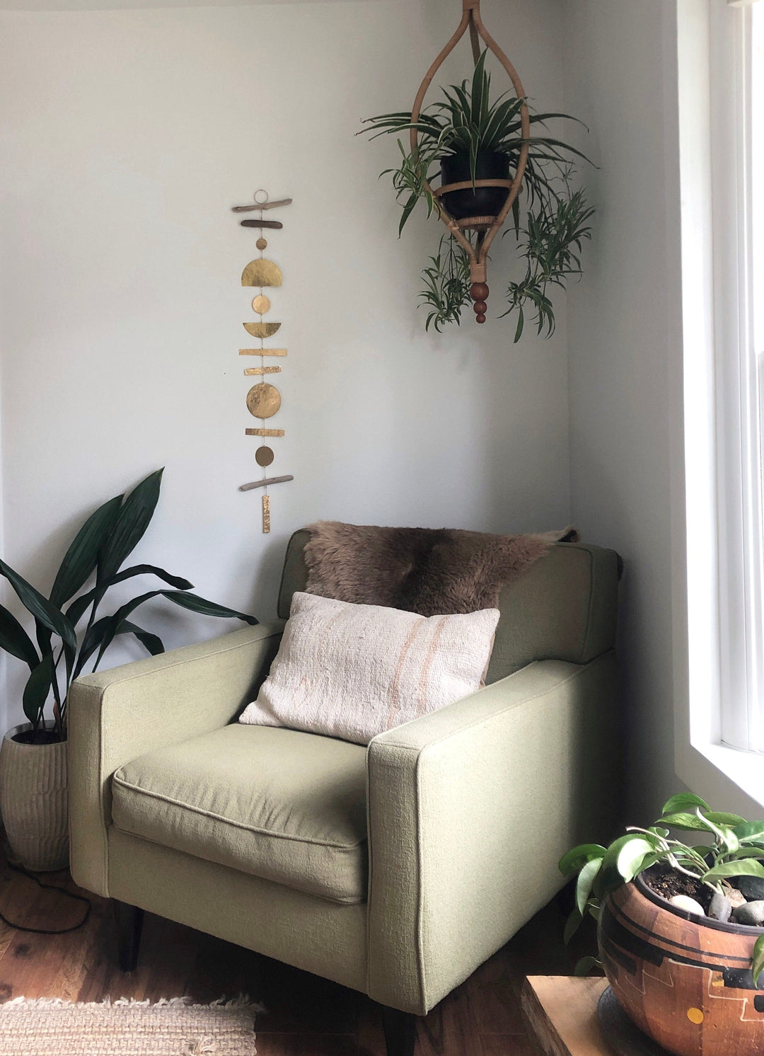 Hanging wooden ornament mobile with round discs and bead details