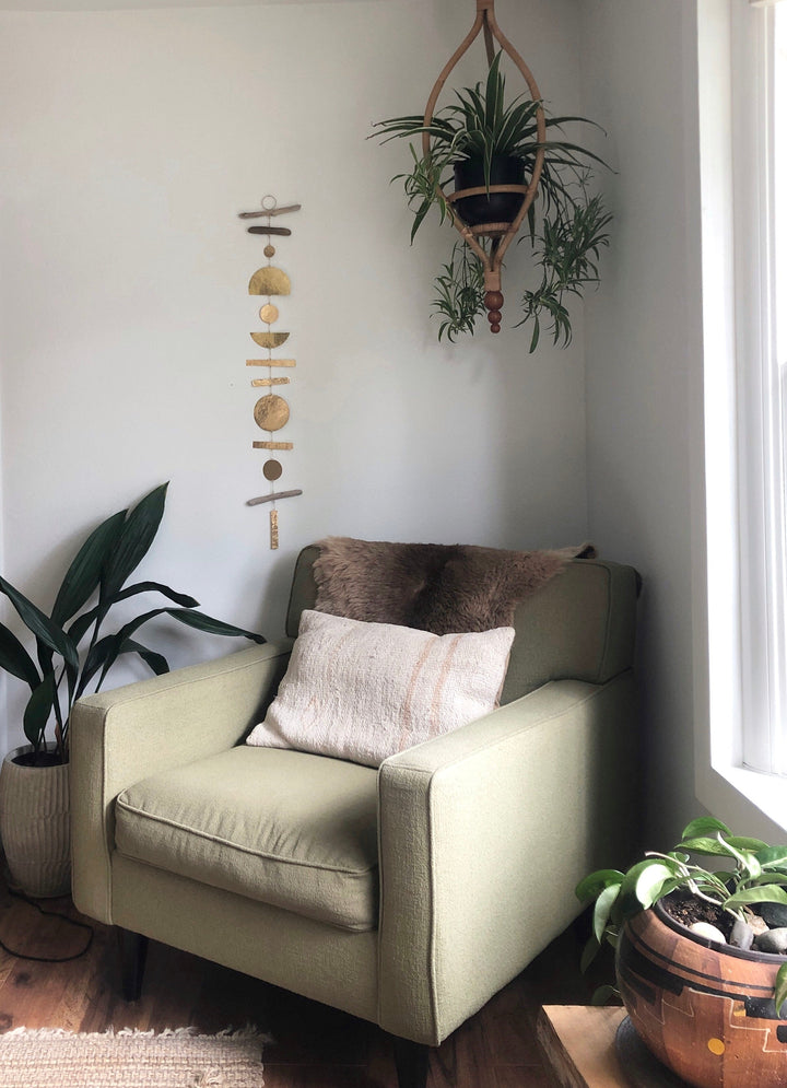 Hanging wooden ornament mobile with round discs and bead details