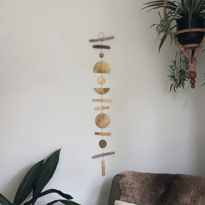 Hanging wooden ornament mobile with stacked round discs and bead accents
