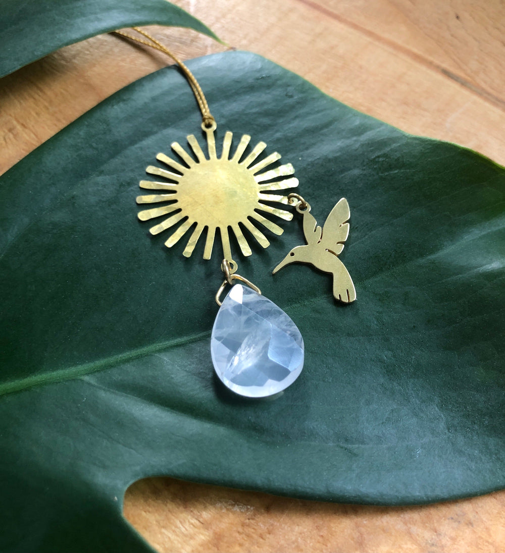 Hummingbird sunburst ornament with rose quartz teardrop pendant on a gold cord