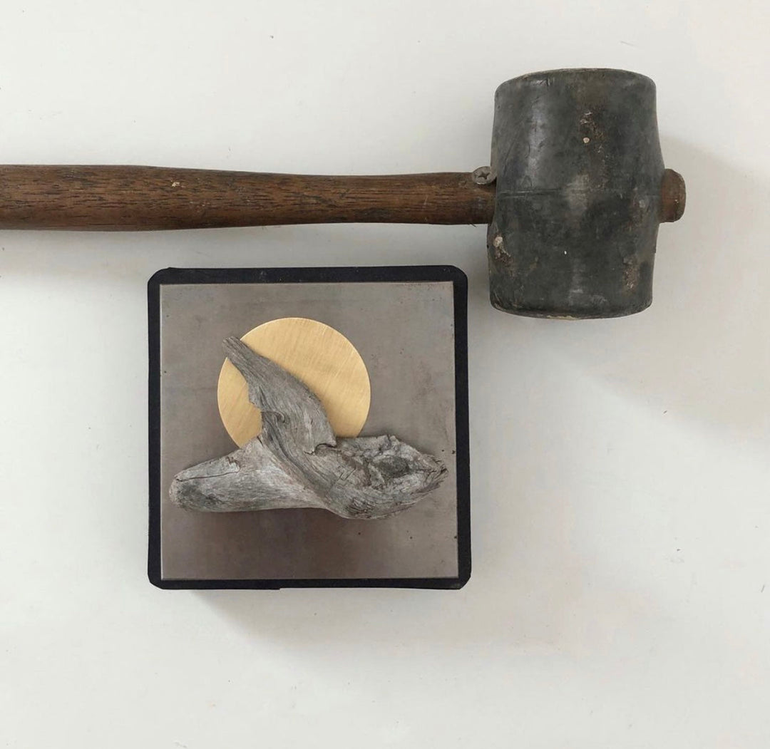 Small framed wall sculpture with gray driftwood bird and gold circular metal disk